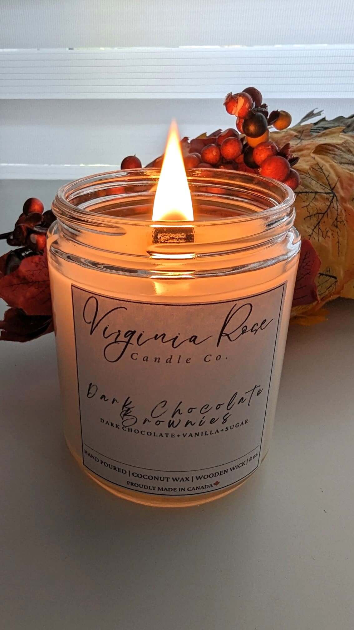 A lit Dark Chocolate Brownies Candle from Virginia Rose Candle Co. 