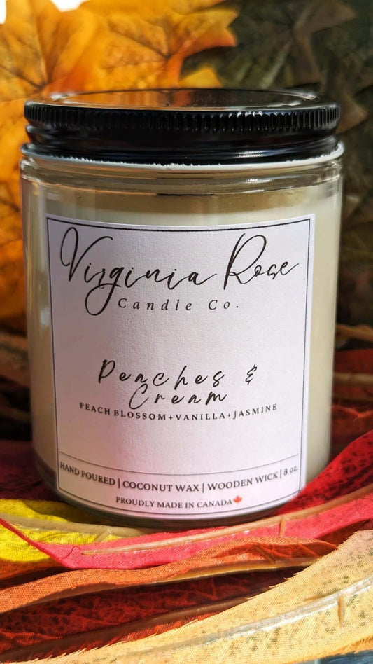 Jar with black lid with Virginia Rose Candle Co. Logo printed on it. The candle scent is Peaches and Cream.